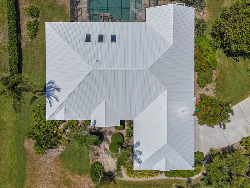 Aerial view of an intact metal roof on a Florida coastal home