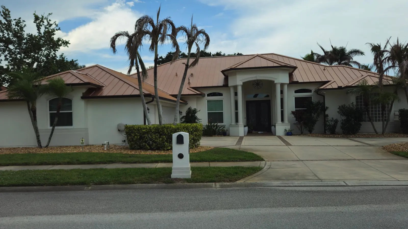 Copper-colored standing seam metal roof with hip sections on a home in Merritt Island, FL